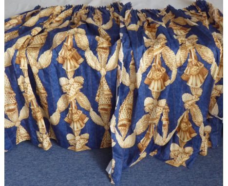 A pair of blue and gold lined curtains in a striking pattern of ribbons and tassels, pencil pleat heading (each curtain appro