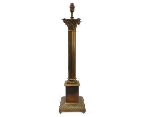 A large brass table lamp modelled as a classical-style Corinthian column with acanthus capital and reeded stem, together with