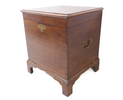 A George III period oak commode box; the moulded top with butterfly hinges, two brass swan neck side carrying handles and rai