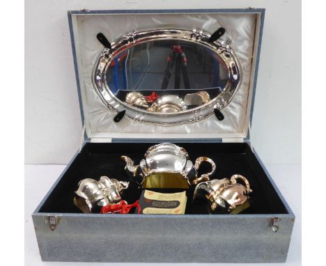 An unusual silver-plated ceramic cased three-piece tea service; comprising ornate teapot, two-handed lidded sucrier and milk/