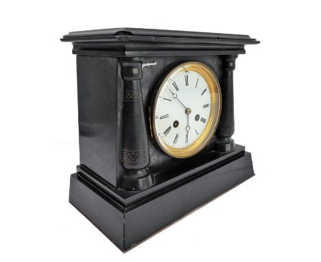 A 19th century slate mantle clock, the white enamel dial with Roman numerals, flanked by two tapering columns incised in the 