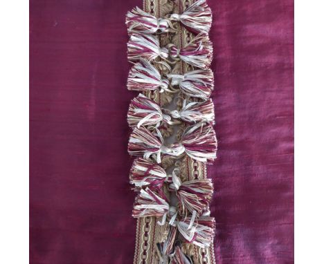A pair of burgundy slub silk curtains edged with decorative tasselled braid, triple pinch pleat heading, woollen thermal lini