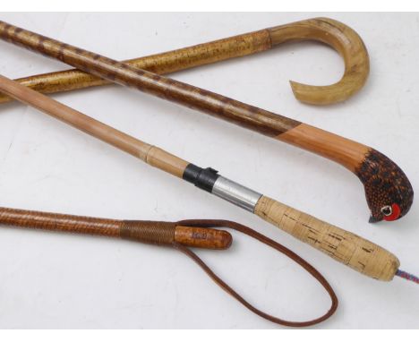 Three walking sticks and an early 20th century leather riding crop;&nbsp;one stick with its handle carved and coloured as a p