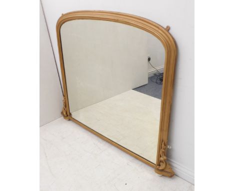 A large 19th century overmantle looking glass (re-gilded / repainted); moulded arch frame and acanthus carved lower base with