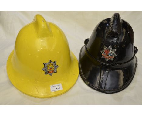Derbyshire yellow fire service fireman's helmet and a Newcastle and Gateshead fire service patent leather helmet with origina