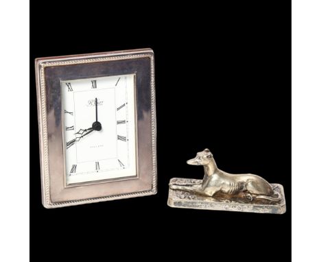 R CARR - a silver-fronted quartz mantel clock, and a silver plated Greyhound design paperweight 