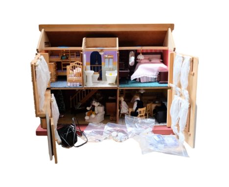 A modern doll's house, spread over 2 floors, with fitter interior, includes associated furniture, and several figurines, L65c