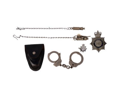 A group of Police items, to include 2 Metropolitan Police whistles, a badge, and a pair of leather-cased cufflinks etc 
