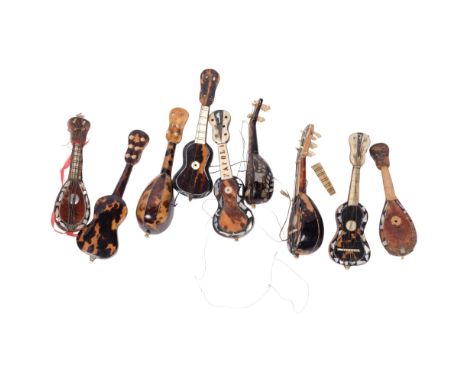 A collection of miniature Italian tortoiseshell and mother-of-pearl mandolins and guitar (9)All in need of attention 