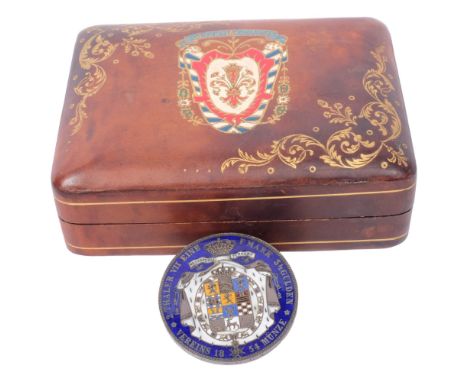 A Continental silver and enamelled coin converted to a brooch, "Necaspeera Terrent", and an Antique painted and gilded leathe