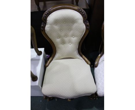 Victorian walnut nursing chair, with scroll carved cresting rail, button upholstered back, upholstered serpentine front seat,