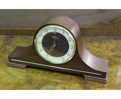 Hermle Germany mahogany mantle clock, the white dial with Arabic numerals, raised on bracket feet. 42.5cm wide