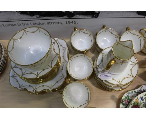 Paragon China porcelain tea service, with gilt foliate swag decoration, consisting of twelve teacups and saucers, twelve side