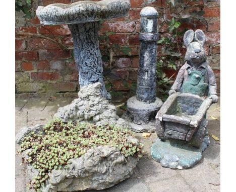 Selection of garden ornaments including a bird bath, lighthouse, rabbit &amp; planter