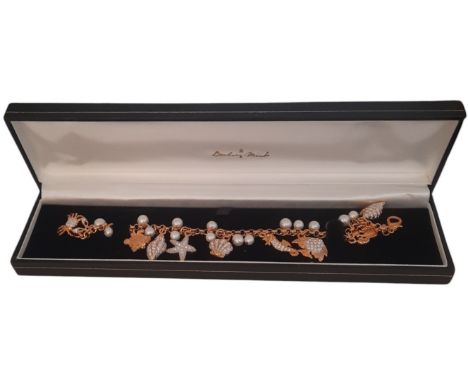 Danbury Mint The Treasures of the Sea Charm Bracelet in original box,  features 16 cultured freshwater pearls and 9 18n carat