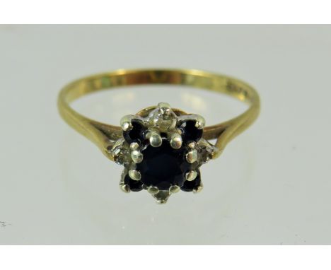 9ct Yellow gold ring set in a Diamond and Sapphire flower shape.  Finger size 'O-5'  1.7g See photos. 