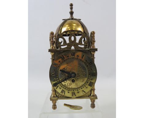 Small brass Smiths lantern mantle clock, approx 7" tall and in working condition.