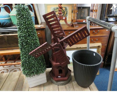 Wooden windmill set on concrete base (25 inches tall) together with an imitation shrub and a large planter.  See photos.  S2