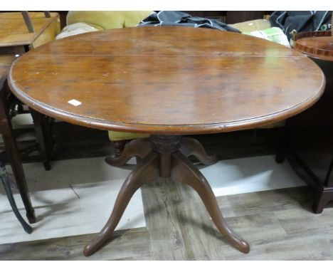 Circular Dining table raised on four bracket feet with central turned column. Has the benefit of a removeable extending centr