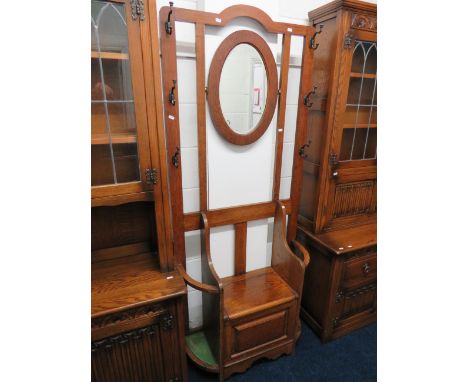 Early 20th Century Oak Hallstand of superior quality. Lifting Oak seat with twin stick &amp; Brolly stands. Oval Bevelled gla