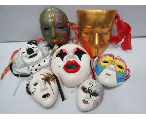 Various ceramic clown and face wall plaques.