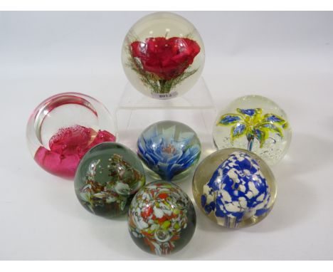 6 Art glass paperweights and one Haford Grange paperweight.