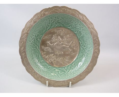 Chinese bowl made from metal and ceramic with dragon detail, Qinglong mark to the base.