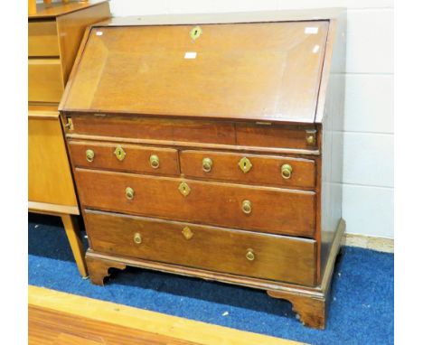 Old Oak Bureau raised on bracket feet it measures H:40 x W:36 x D:20 Inches.  See photos.   S2