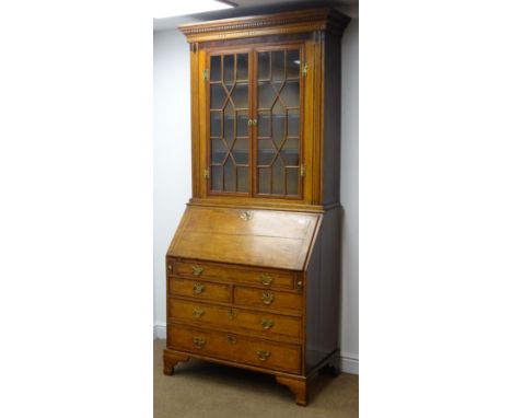 19th century oak and mahogany banded bureau bookcase, projecting cornice, dentil frieze, astragal glazed doors, three adjusta
