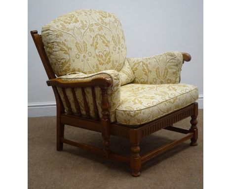 Ercol medium elm framed armchair, carved cresting rail, turned splat and legs joined by stretchers, upholstered with light go