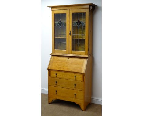 Early 20th century light oak bureau bookcase, stained and leaded glass doors enclosing two adjustable shelves above fall fron