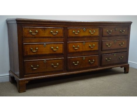 George III mahogany cross banded Lancashire oak dresser, moulded top above nine graduating drawers, brass swan necked handles