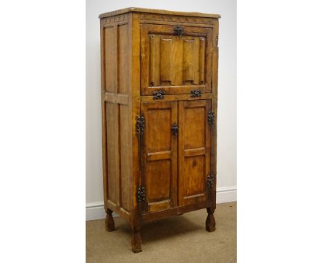 Gnomeman narrow oak cocktail cabinet, fall front enclosing shaped shelf above two cupboard doors, tapering supports (W64cm, H