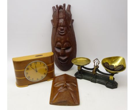 Art Deco walnut two-florin coin operated clock, set of cast iron weighing scales with weights and two carved masks, H57cm 