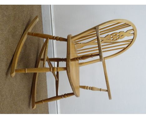 Beech wheel back rocking chair, turned stick splat and supports W61cm