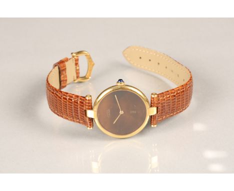 Must de Cartier silver gilt wrist watch with brown dial. Gilt hands, sapphire crown on leather Cartier strap. Dial diameter 2