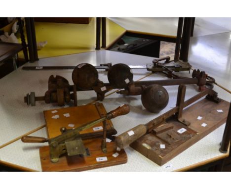 A vintage beam or pig balance; a set of three vintage crown green bowls; a leather worker's notching guillotine by Hampson Be
