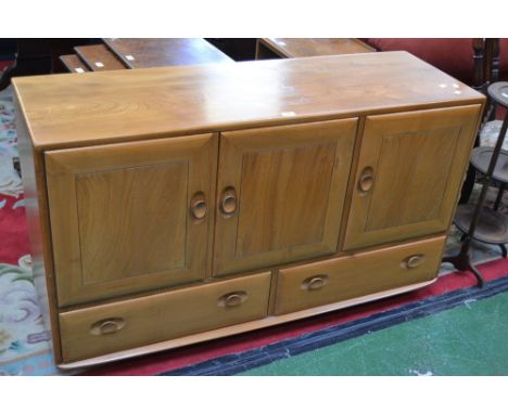 An Ercol Windsor sideboard, three cupboards over two long drawers, casters 