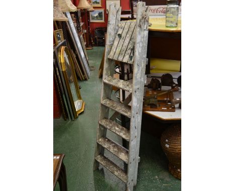 A wooden six-step, step ladder