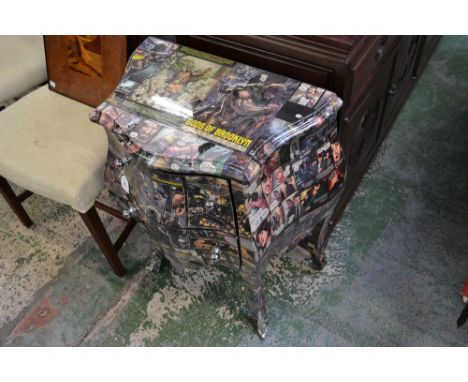 A contemporary two drawer serpentine commode, decorated with  comic magazine pages 
