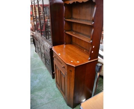 An oak dresser of small proportions by Marcus Furniture, shaped uprights, long drawer over linenfold panel door to base.