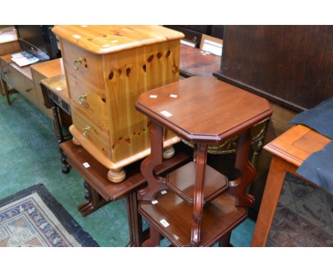 A reproduction giltwood console table; a pine three drawer bedside chest; an oak dropleaf tea trolley; a mahogany nest of thr