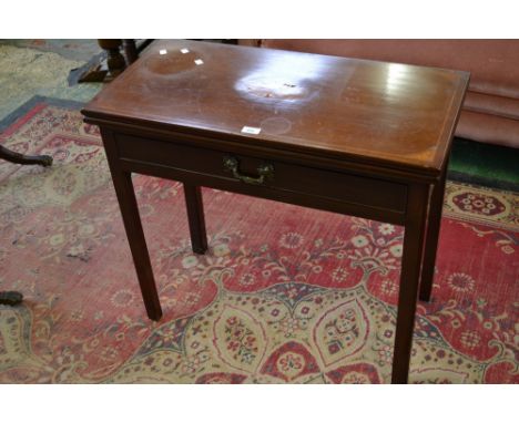 An early 19th century mahogany card table inlaid with satinwood fan shaped patera, baize playing surface, single drawer to fr