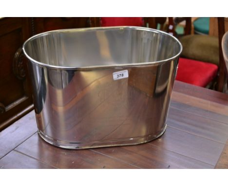 A modern chrome reproduction champagne trough, inscribed with Lily Bollinger quote 'I drink it when I'm happy and when I'm sa