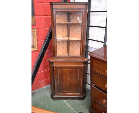 An Edwardian inlaid floor standing corner cabinet, canted angles, glazed cupboard to top, single panel door to base, satinwoo