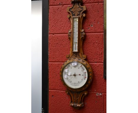 An oak aneroid banjo barometer, enamel dial.