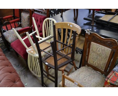 A late Victorian oak salon chair, padded back and seat; a beech lath back kitchen chair; two painted spindle back kitchen cha