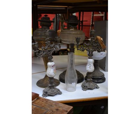 Lighting - a Victorian oil lamp; others, cast iron and milk glass; a pair of candelabra (5)