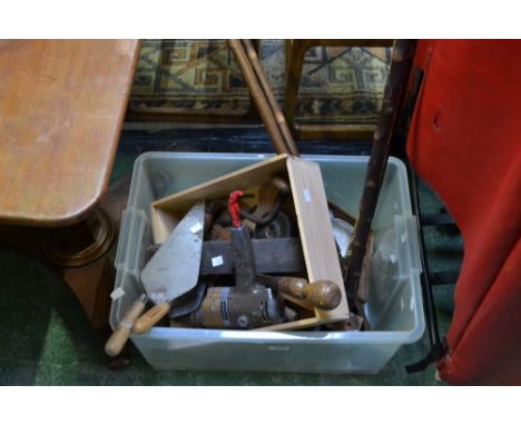 A quantity of wooden walking canes and tools 