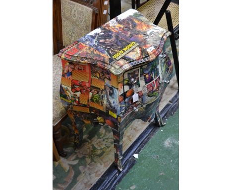A contemporary two drawer serpentine commode, covered in comic pages 